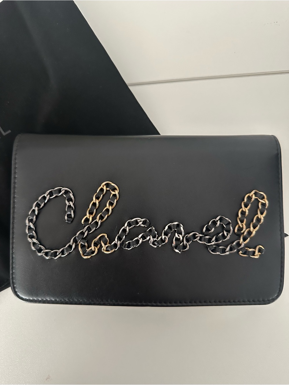 CHANEL Black Leather Clutch with Mixed Metal Chain Script